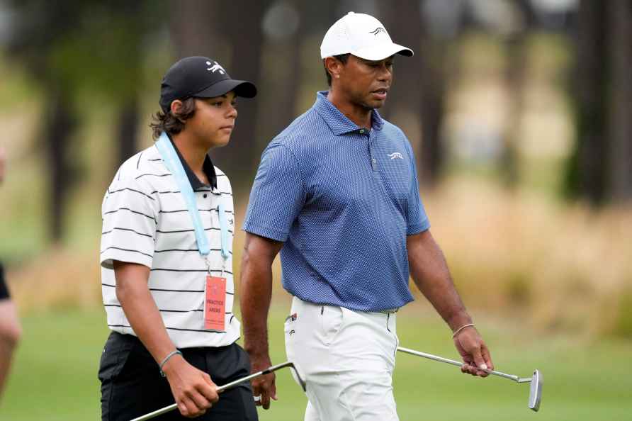 Tiger Woods walks with his son Charlie