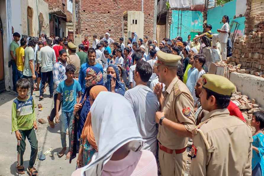 Ghaziabad: Police and locals near the house where a fire broke out...