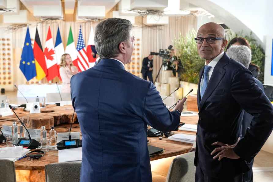 Microsoft CEO Satya Nadella, left, and Flavio Cattaneo, CEO of ENEL...