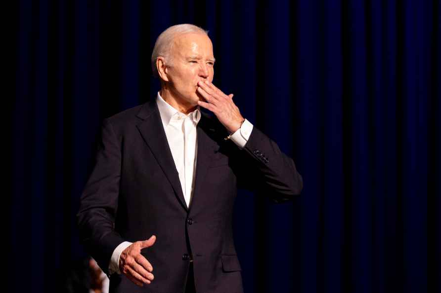 President Joe Biden blows a kiss as he arrives for a campaign event...