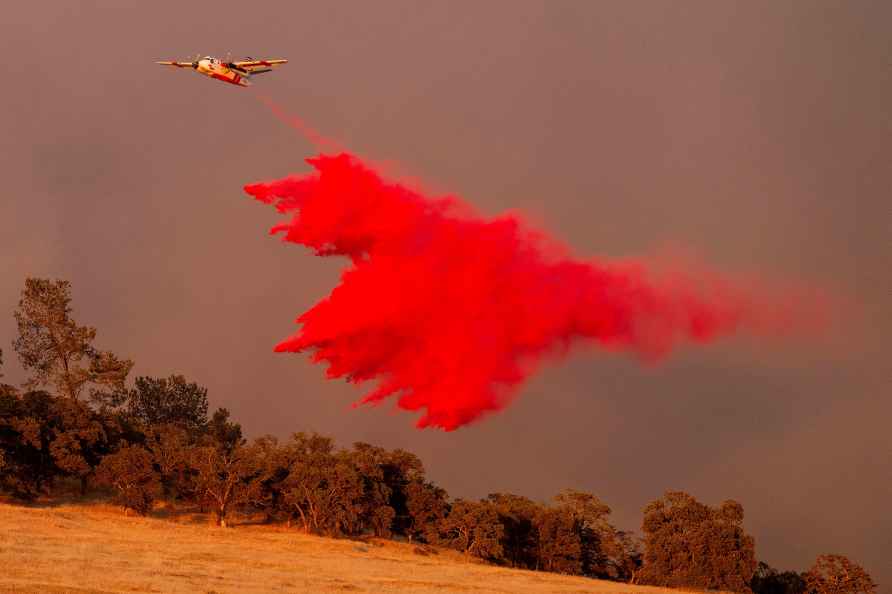 An air tanker drops retardant while battling the Aero Fire