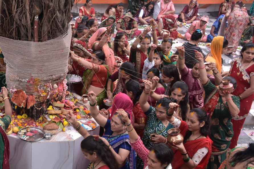 Surat: Married women tie threads around a Banyan tree as part of...