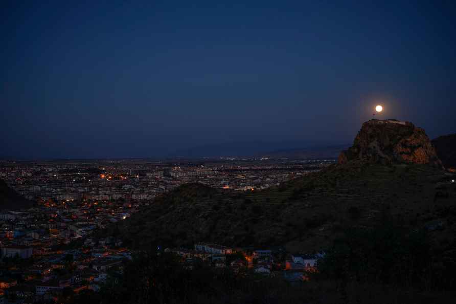 A full moon rises behind old Karahisar castle in Afyonkarahisar