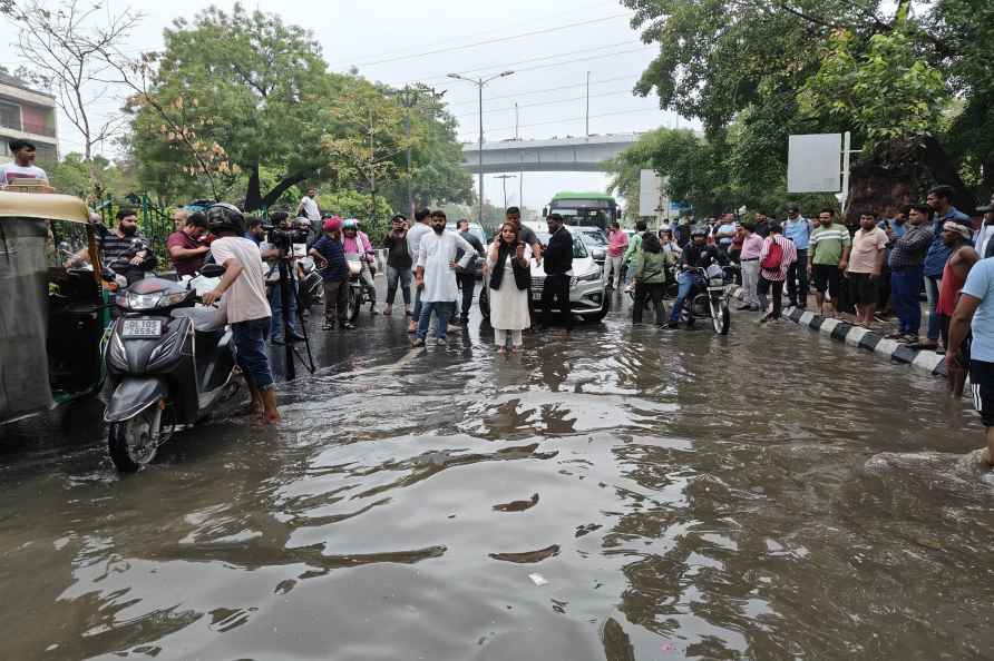 Shelly Oberoi inspects a waterlogged area