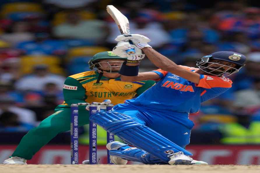 India's Axar Patel, right, hits a six during the ICC Men's T20 World...