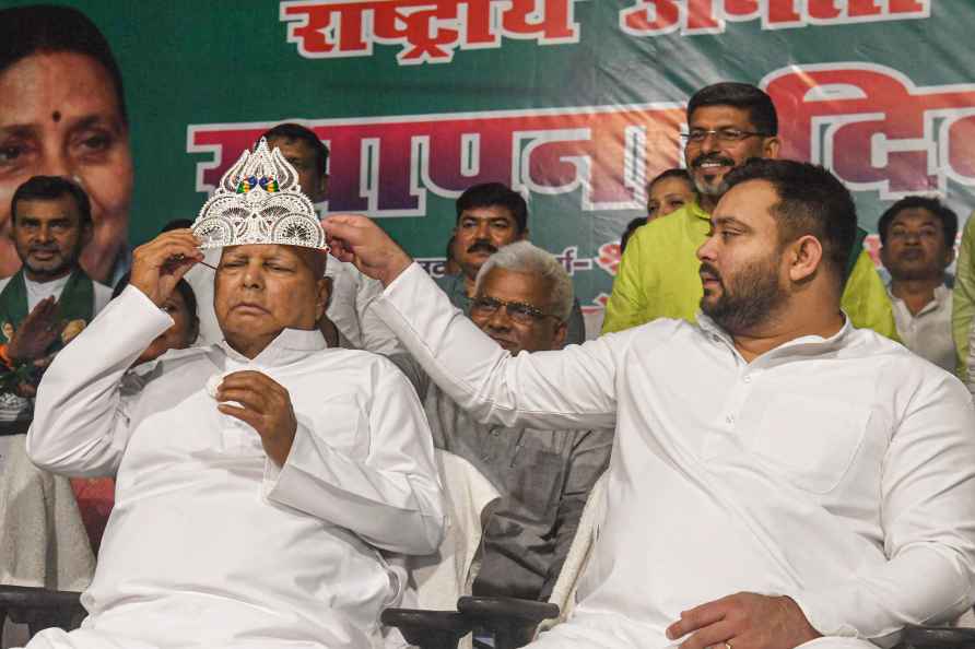 Patna: RJD chief Lalu Prasad wears a sliver crown during the party...