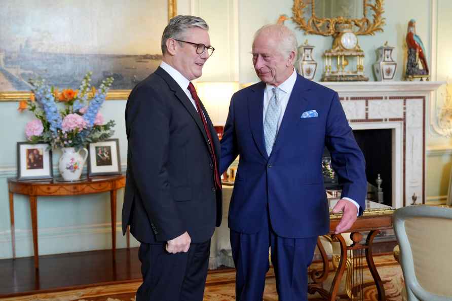 Britain's King Charles III, right, speaks with Keir Starmer