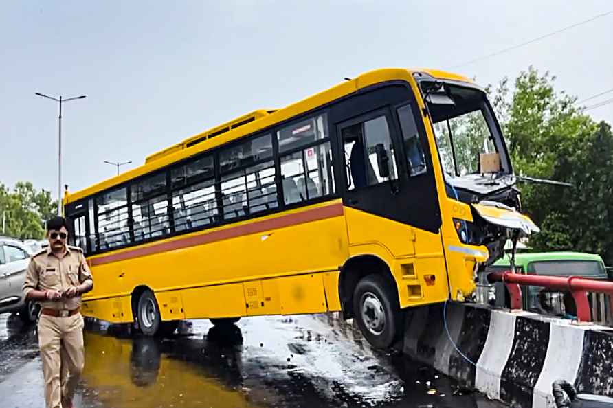 Private school bus hangs down flyover's railing