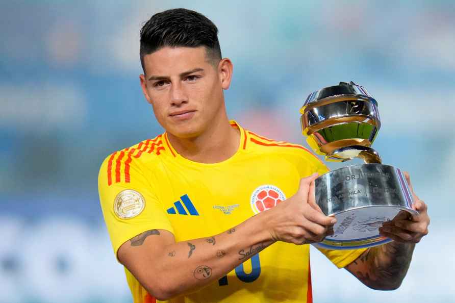 Colombia's James Rodriguez holds the player of the tournament trophy...