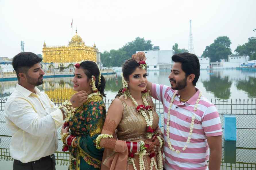 Amritsar: Newly-wed couples adorned with flowers visit Durgiana ...