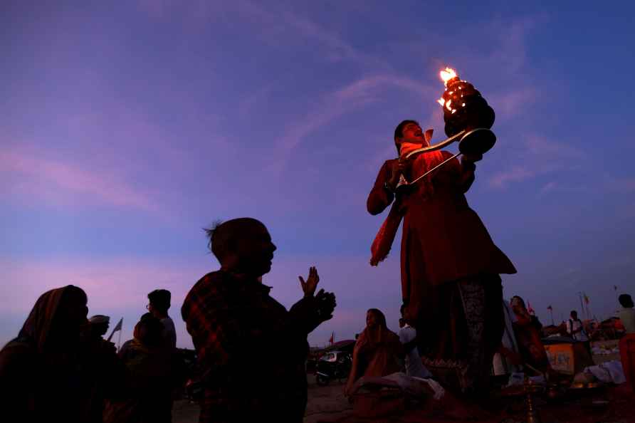 Prayagraj: A priest performs Ganga Aarti at the Sangam on the Guru...