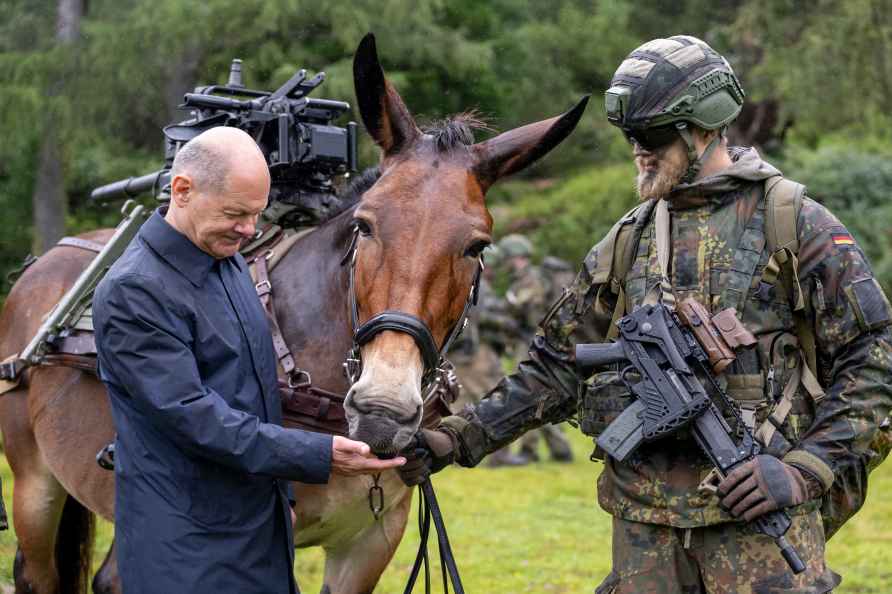 German Chancellor Olaf Scholz, left, visits the mountain infantry...