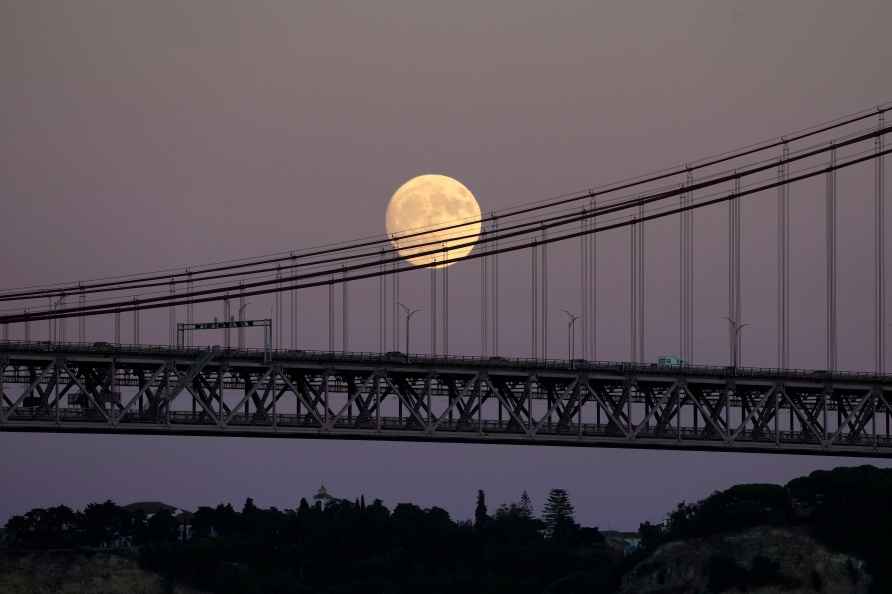 A nearly full supermoon rises