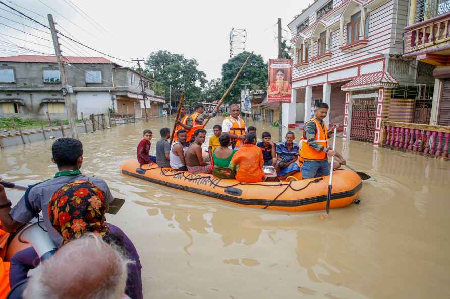 Agartala: NDRF personnel evacuate people from a flood-affected area...