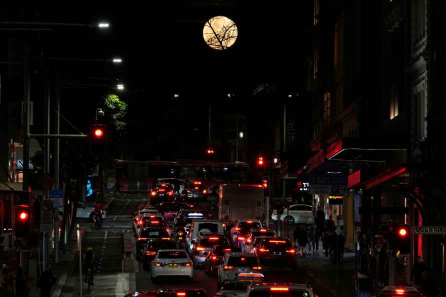 Supermoon rises over a Sydney street