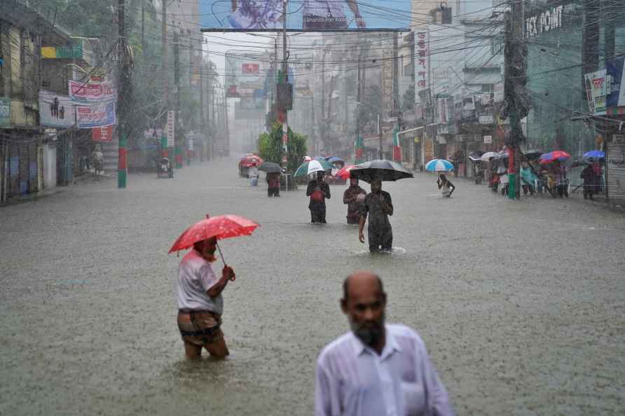 People navigate a flooded street