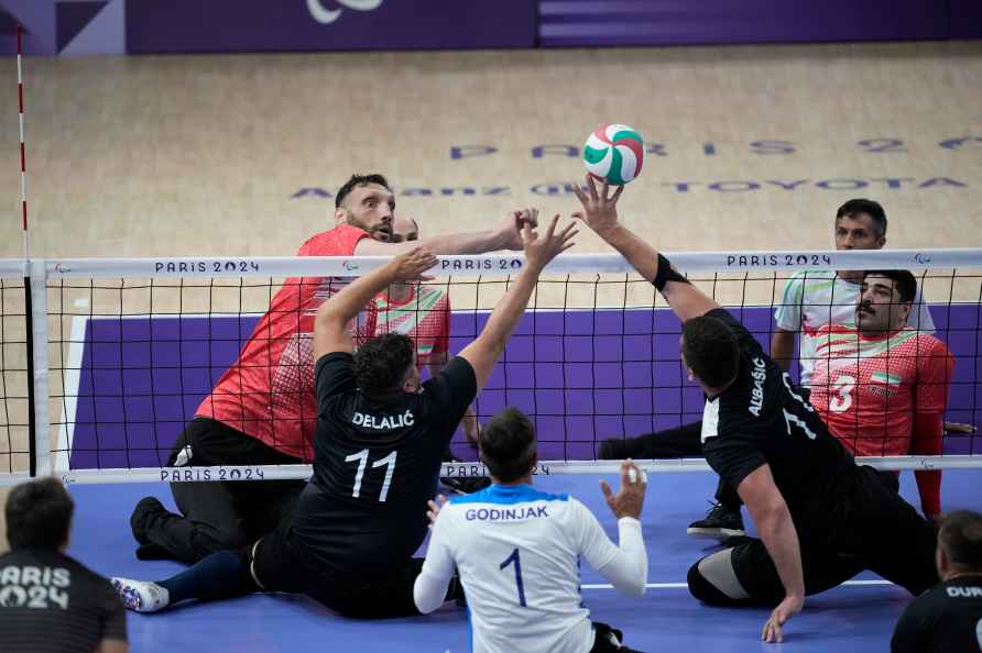 Bosnia's Sabahudin Delalic, left, and Safet Abbasid try to block...