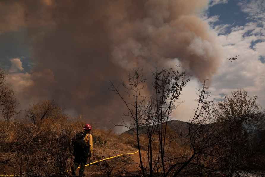 A firefighter walks up a hill