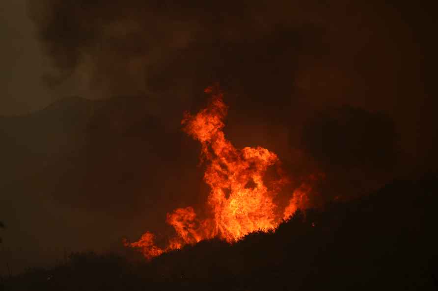 Line Fire rise over a hilltop