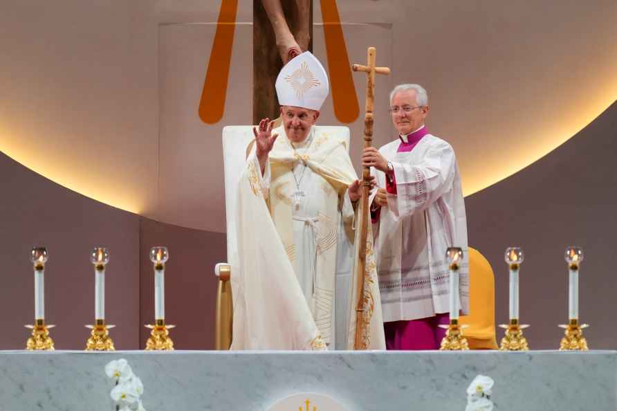 Pope Francis gestures to attendees after presiding over a holy mass...