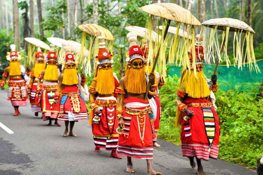 Kozhikode: Onapottans, local folk artists, perform during the Onam...