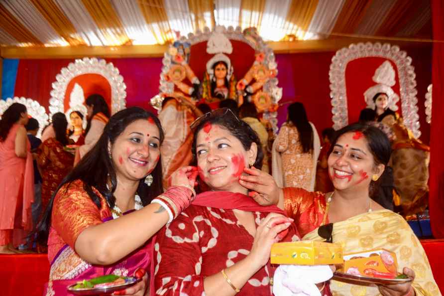 Kanpur: Women apply vermilion to each other during Durga Puja festival...