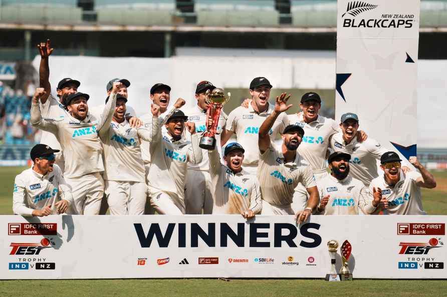 Mumbai: New Zealand's players pose with the trophy after winning...