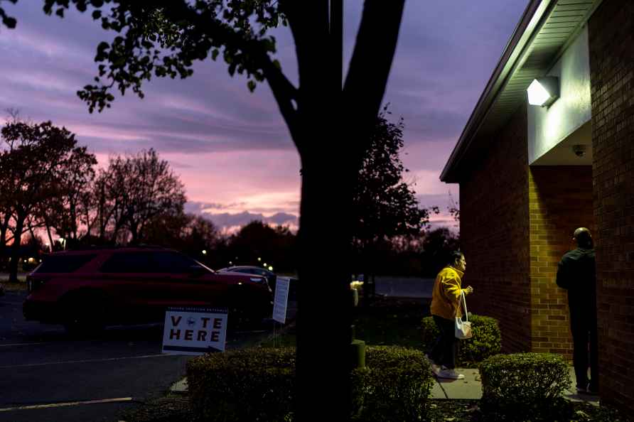 A voter enters a polling site to wait in line for the polls to open...