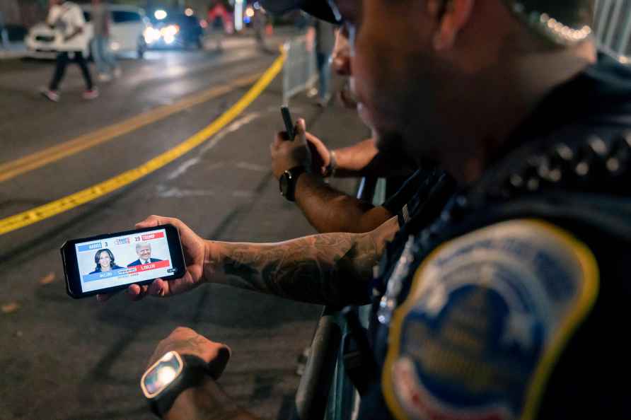 A member of the Metropolitan Police Department watches live election...