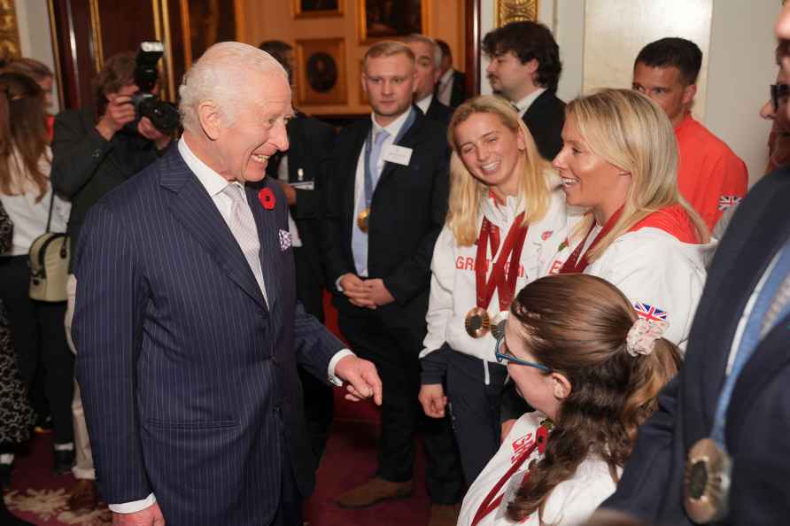 Britain's King Charles III talks to guests as he holds a reception...